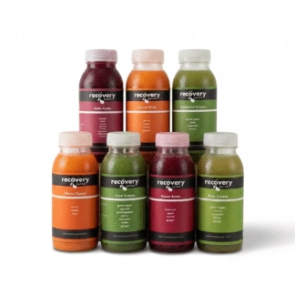Daily Juice Box bundle with 7 different cold-pressed vegetable juice bottles on pure white background.