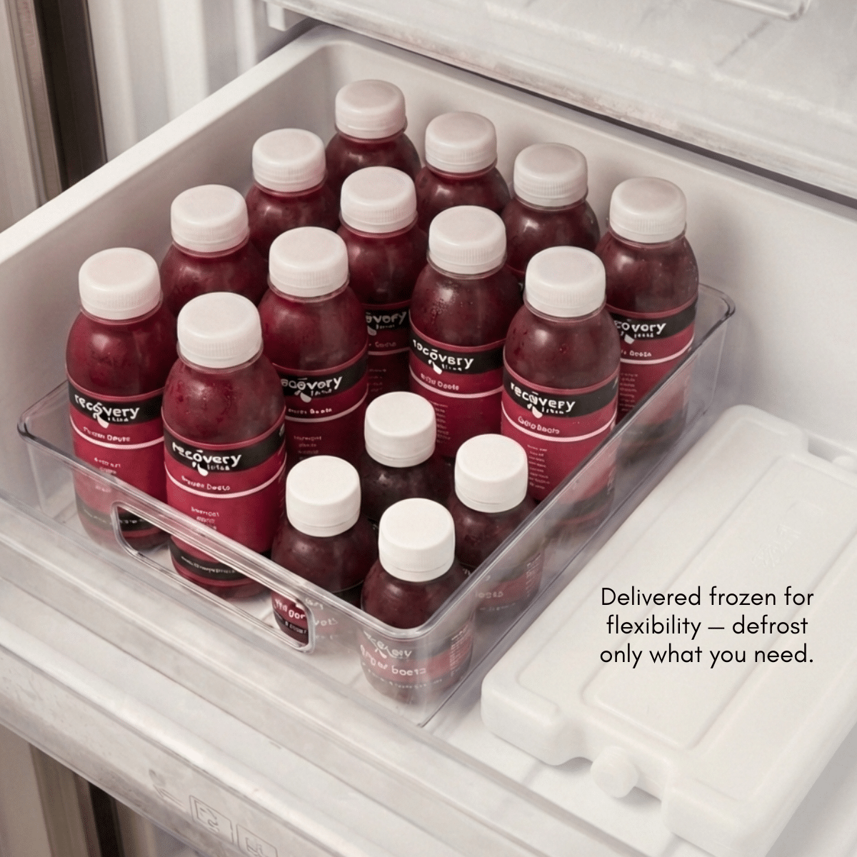 Cold-pressed beetroot juice bottles stored in a freezer drawer, delivered frozen and ready to defrost as needed.