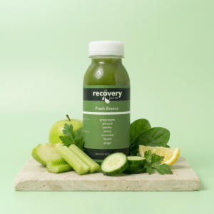 Fresh Greens cold-pressed green juice with apple, celery, cucumber, spinach, parsley and lemon on stone slab