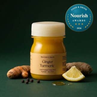 Ginger Turmeric shot with Nourish Awards badge: Recovery Juice Ginger Turmeric shot with a Nourish Awards badge, fresh ginger, turmeric root and lemon