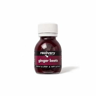 Cold-pressed beetroot ginger shot on a white background for daily energy and blood pressure support.