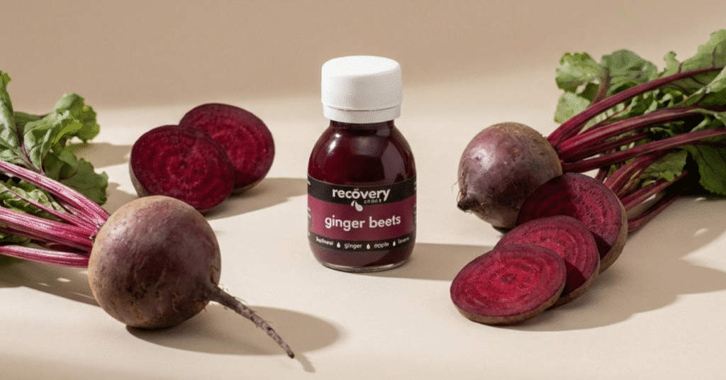 Ginger Beets wellness shot with fresh whole and sliced beetroot in a wide studio setting.