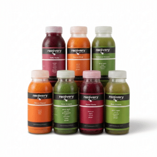 Daily Juice Box bundle with 7 different cold-pressed vegetable juice bottles on pure white background.