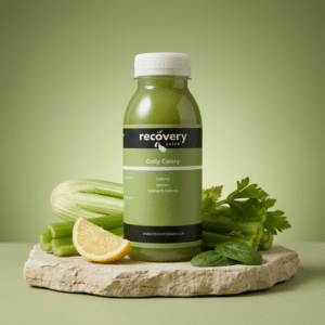 Daily Celery cold-pressed juice with celery, lemon and spinach leaves on stone slab