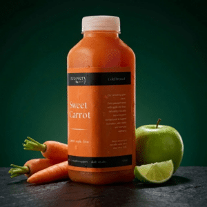 Recovery Juice Sweet Carrot cold-pressed juice bottle with whole carrots, a red apple and a lime on a dark green background